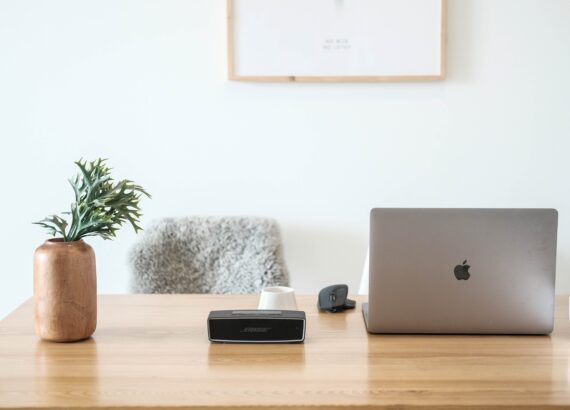 Photo of a desk with plant, speaker, laptop and more. Online therapy in North Carolina can help with EMDR therapy, Anxiety treatment, addiction treatment, grief counseling and perinatal mental health. Learn about your online therapist in North Carolina here!