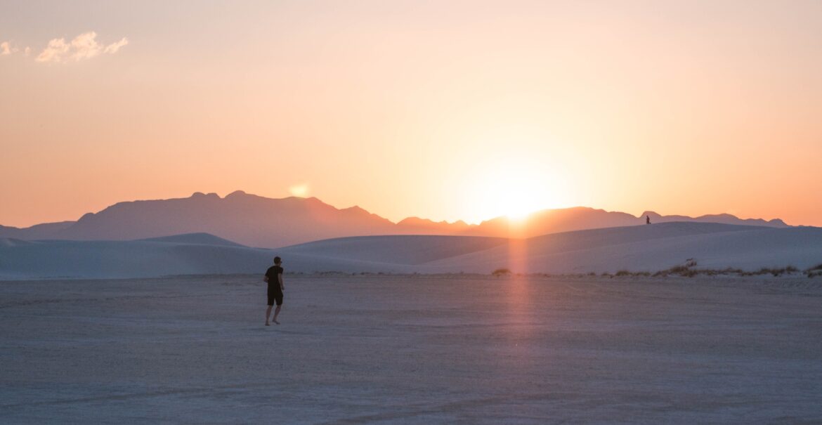 Man running in the desert at sunset. Suffering with trauma related anxiety can make you feel like you are constantly sprinting towards an unknown goal. Learn to slow down and take life in stride with anxiety treatment in Charlotte, NC.
