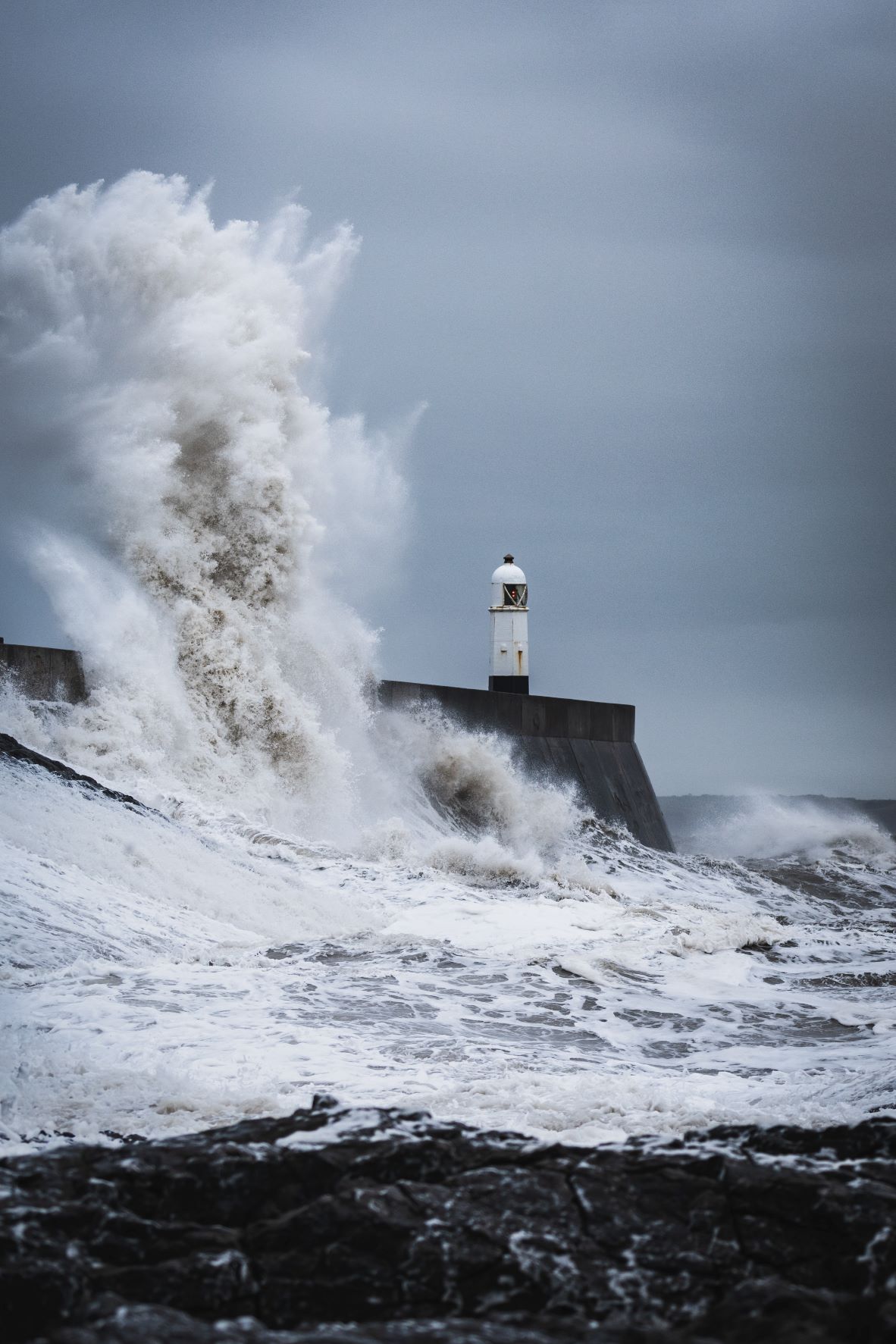 Lighthouse getting bombarded by relentless waves. Trauma related anxiety can feel like being constantly hit with waves of emotion. Learn to calm the stormy sea with anxiety treatment in Charlotte, NC.