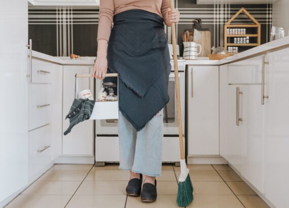 Woman holding a broom and cleaning supplies. OCD support. Compulsive thoughts. Anxiety therapy.