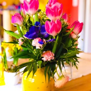 Colorful flowers in a pretty yellow vase. Postpartum depression. Support for depression. Care for mothers. North carolina teletherapy.