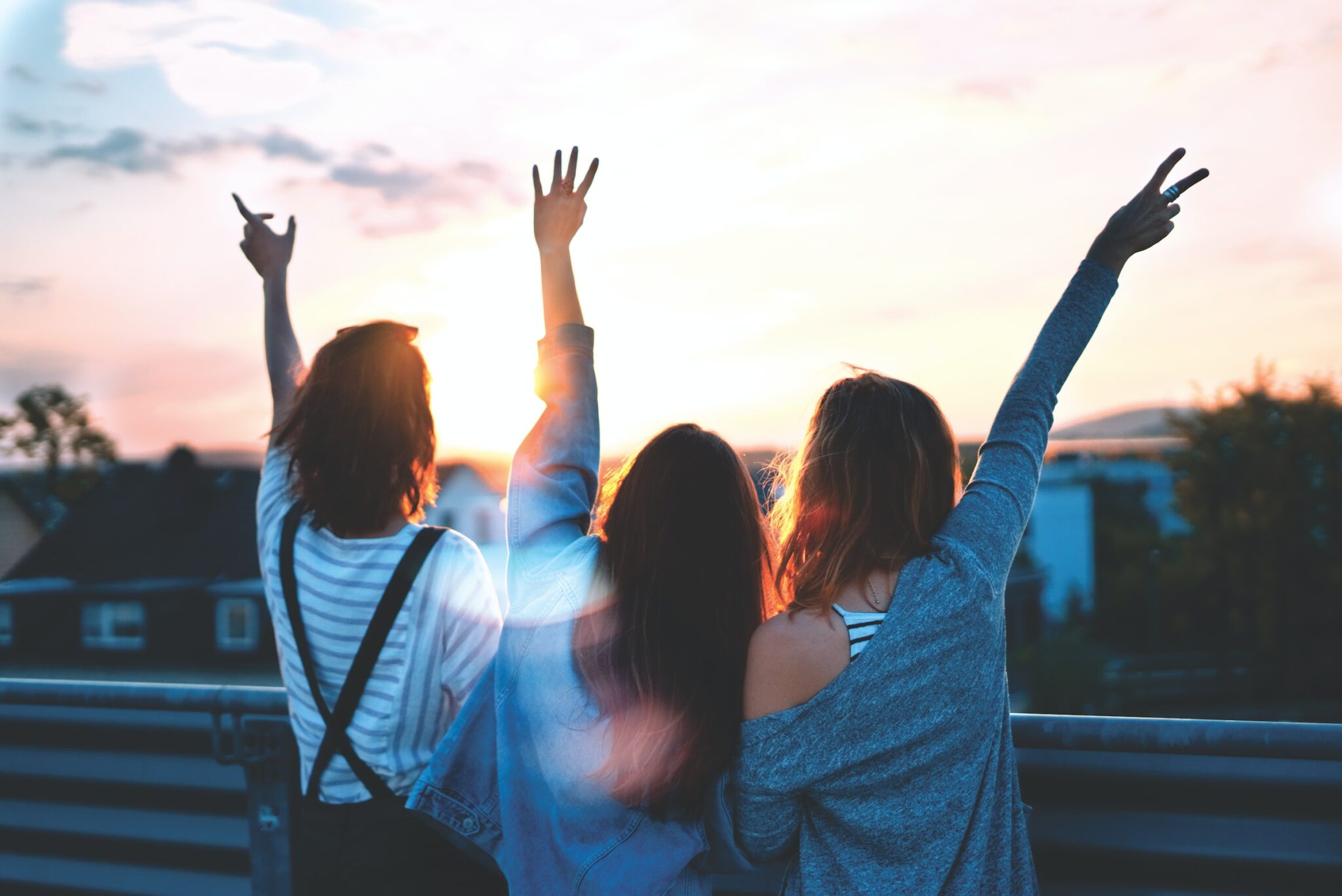 Friends having fun outside at sunset. Improve your communication and recover from codependent relationships with therapy. Counseling for anxiety and depression.